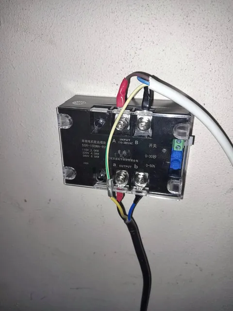 Single-phase motor soft-start module mounted on a wall with wiring connected